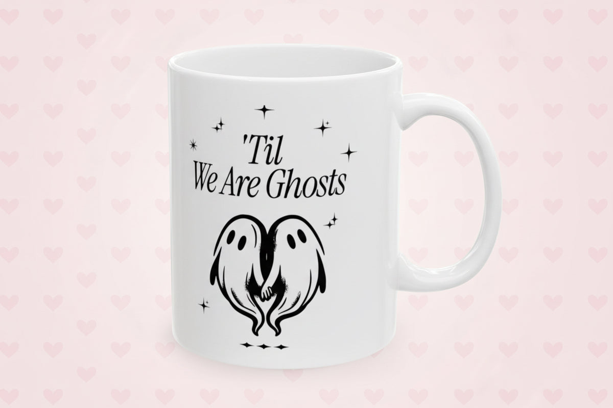 White mug with black text and ghost design on a white background
